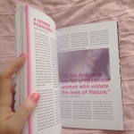 A photograph of a hand holding open a print copy of Doll Hospital Issue One, it is open at the essay 'A Woman Possessed'